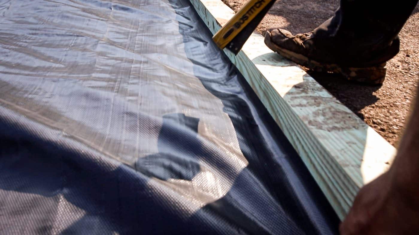 Adding stabilization fabric under a gravel base for a hot tub