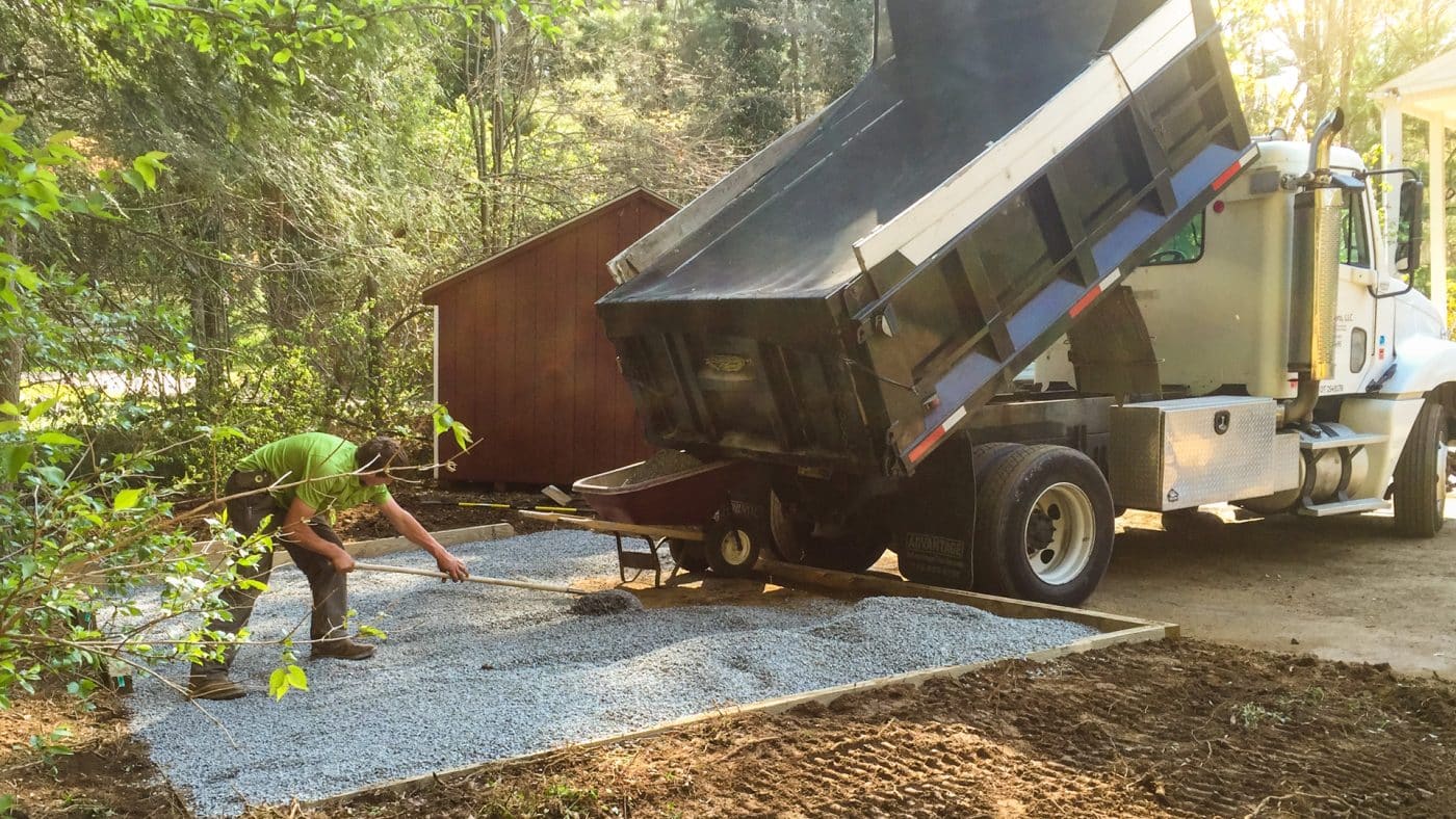 Spreading gravel for a hot tub pad from a dump truck
