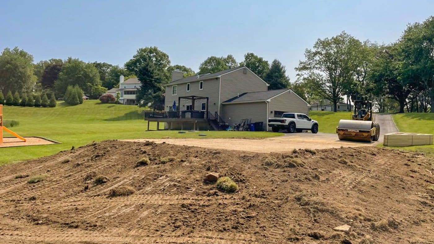 a pole barn foundation by a house being rolled